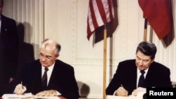 FILE - U.S. President Ronald Reagan and Soviet President Mikhail Gorbachev sign the Intermediate-range Nuclear Forces Treaty at the White House, Dec. 8 1987.